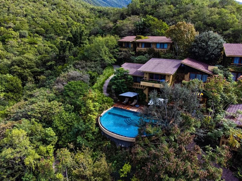 Aerial view of the hotel and pool area with greeny surround at Gamma Hotels