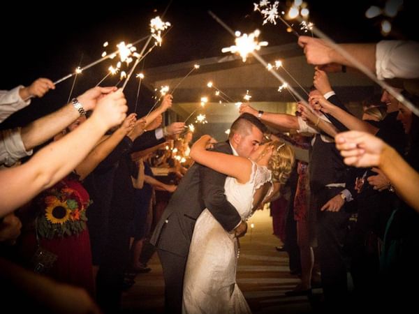 Newlyweds under sparklers.