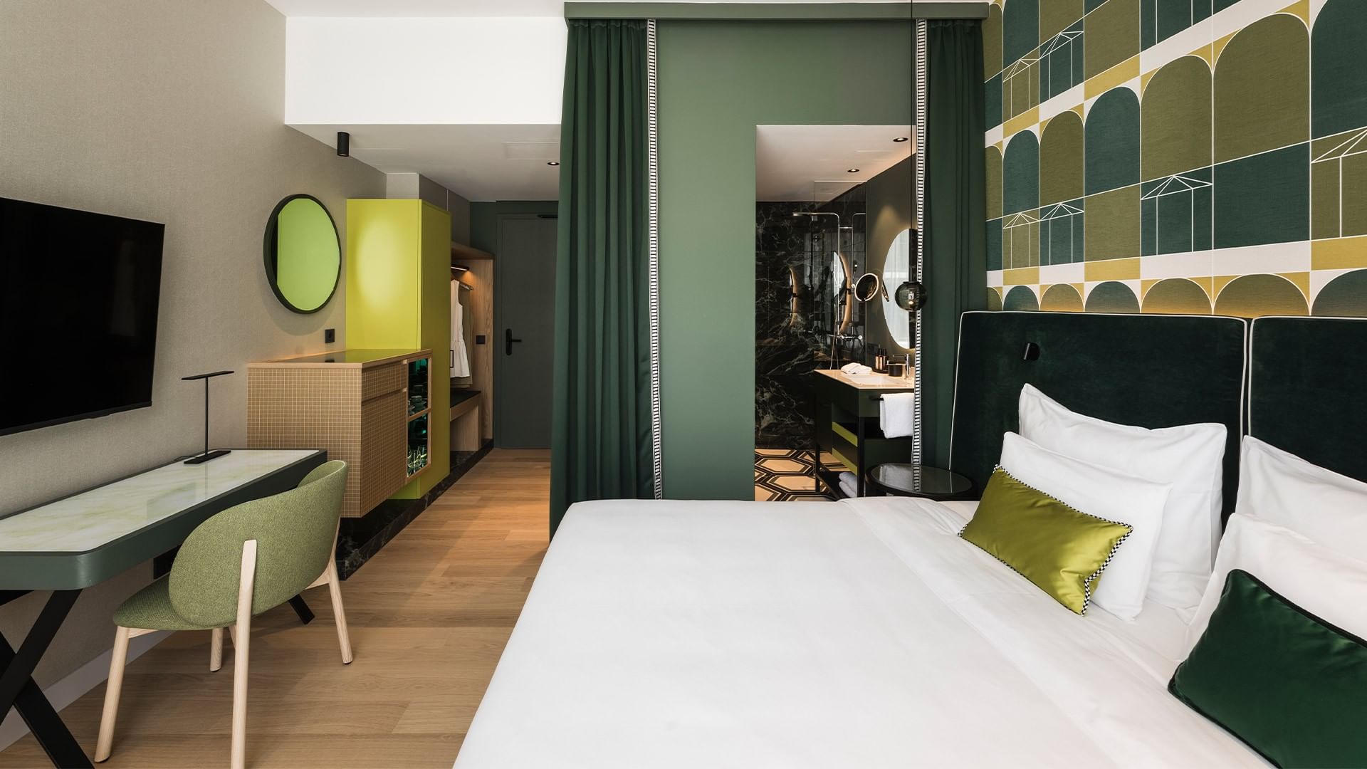 Superior Room with green and white decor at Falkensteiner Hotel Bozen WaltherPark in Bolzano.