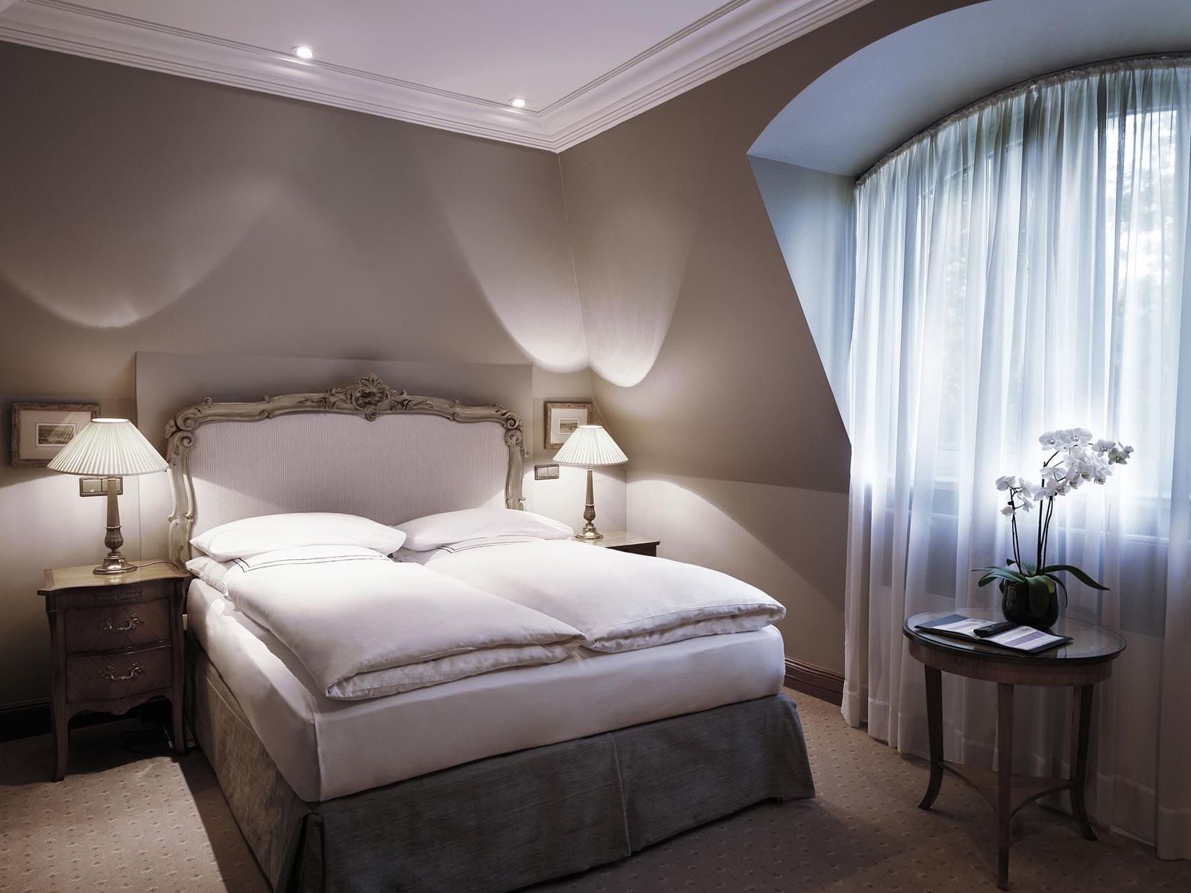 King bed of a King Deluxe at Patrick Hellman Schlosshotel