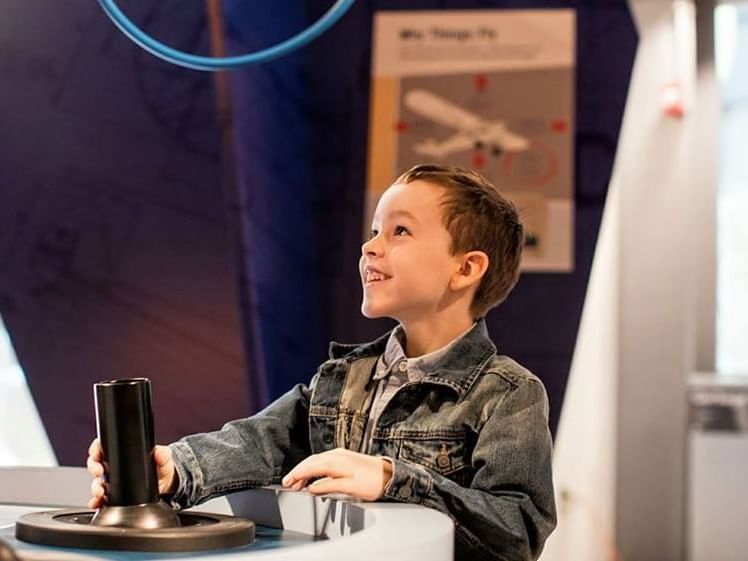 A boy holding a simulator, Discovery Center near Hotel Halifax