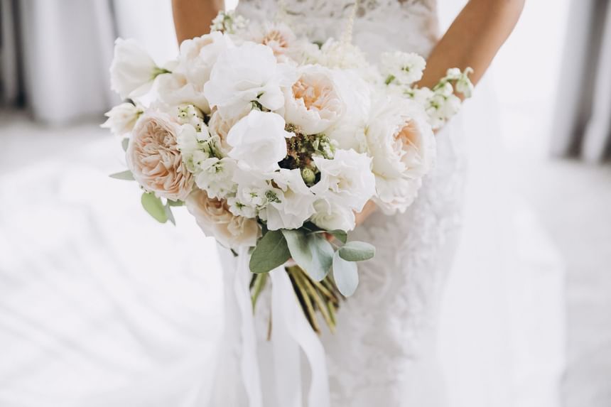 Bride with a flower bouquet at Momentus Hotel Alexandra