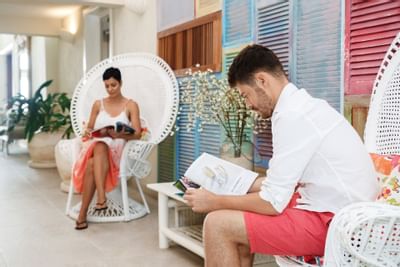A man and a lady reading magazines at Sugar Bay Barbados