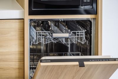 An open dishwasher & microwave at Nesuto Docklands