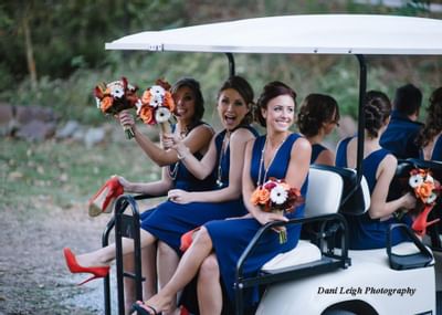 Bridesmaids on a golf cart.