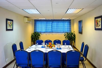 Meeting room with blue chairs and conference table at Dover Beach Hotel