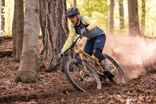 Close-up of a mountain biker through forest near Blackcomb Springs Suites