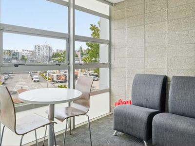 Comfortable seating area with city view and large windows at Student Living Auckland - Beach.