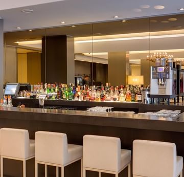 Bar counter with various beverages self in the Lobby Bar at Sylter Hof Berlin