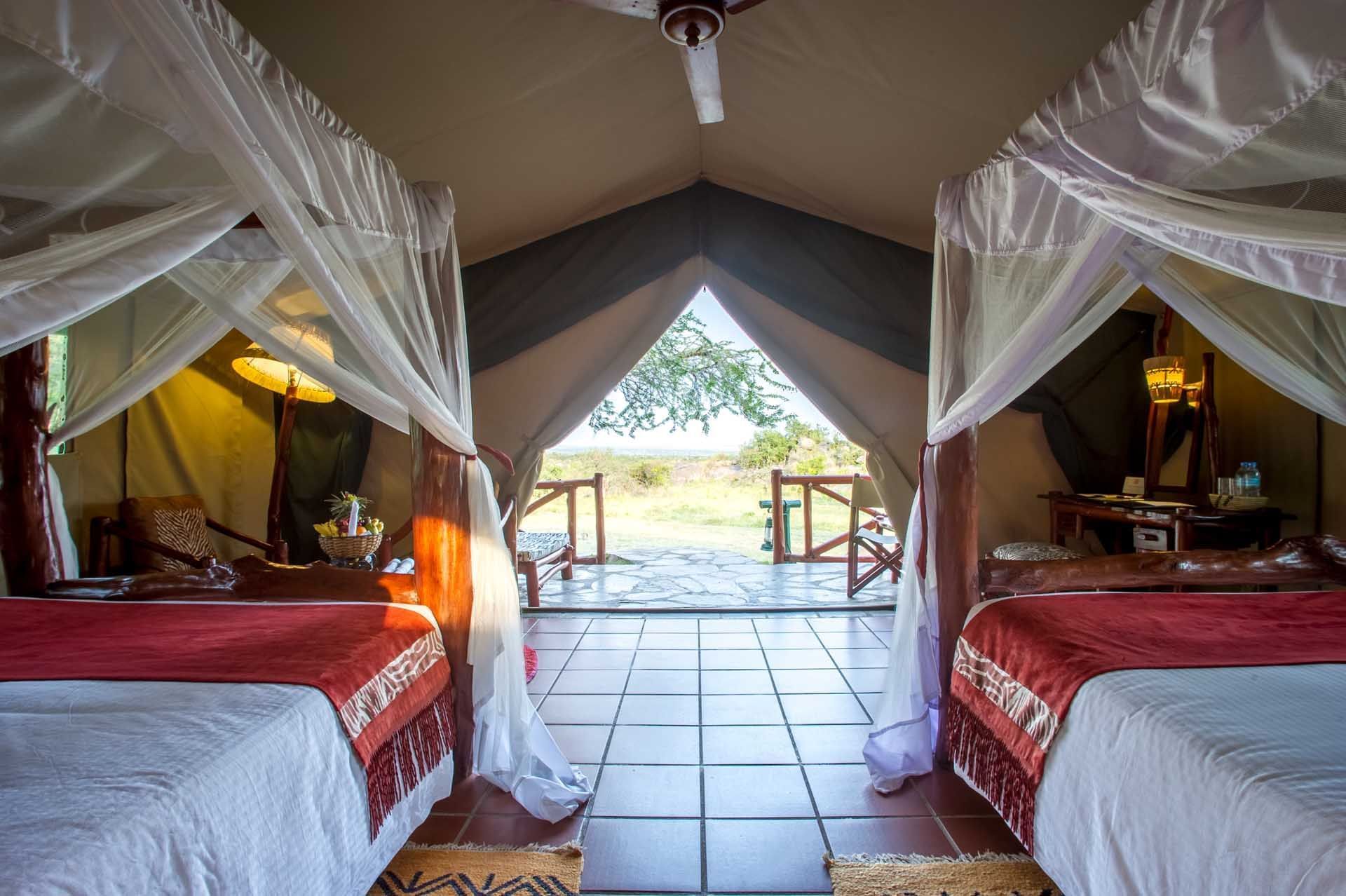 Two beds with curtains in tent at Mbuzi Mawe Serena Camp