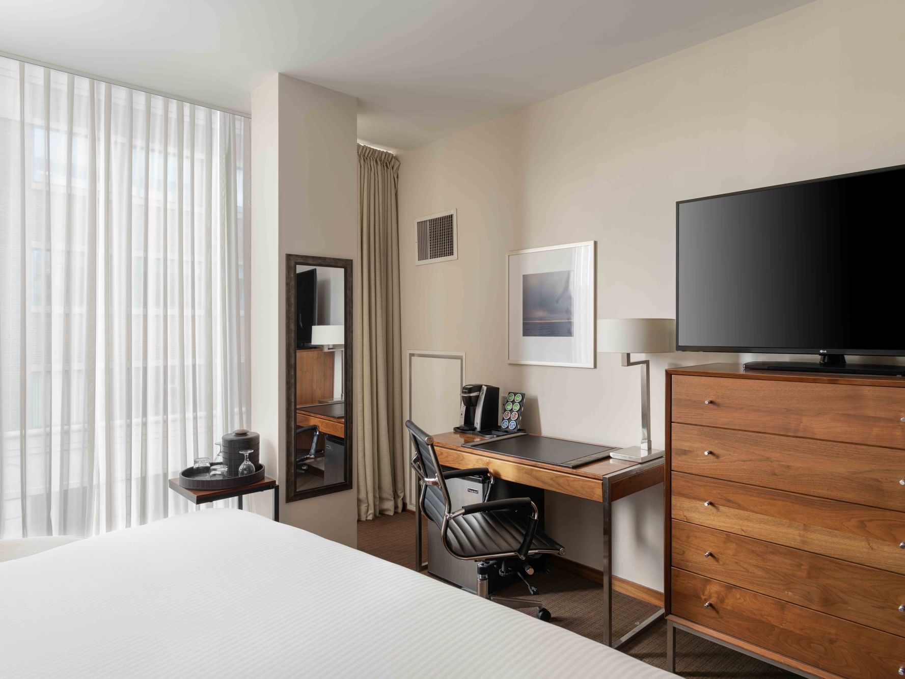 TV & work desk facing the bed in Executive King at Portland Harbor Hotel