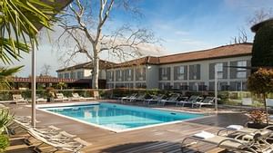 Pool with the seating area at Domaine de la Charpiniere Hotel