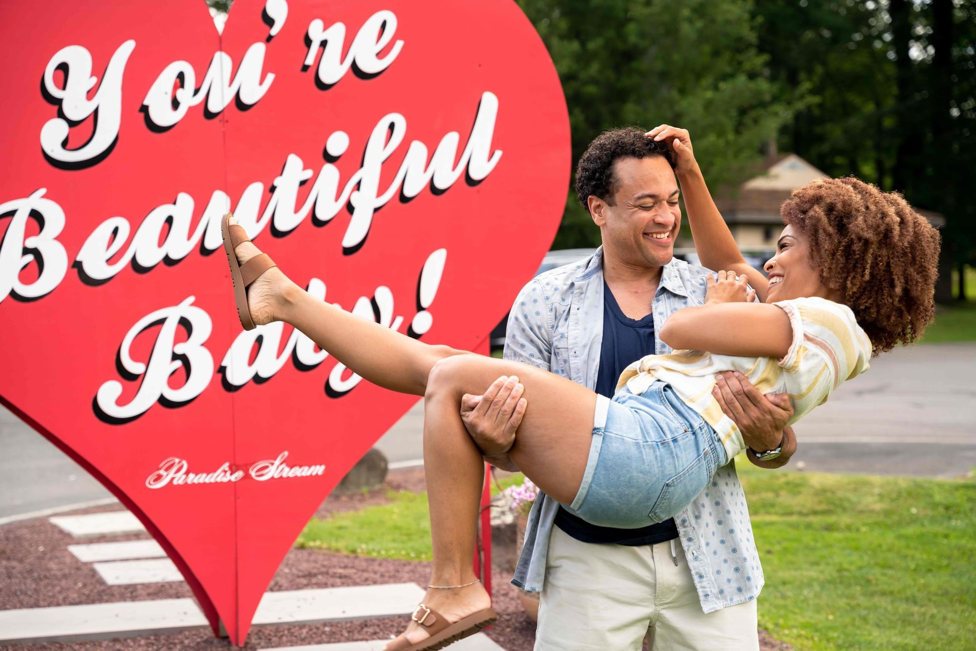 A man holding his woman joyfully and symbolizing 