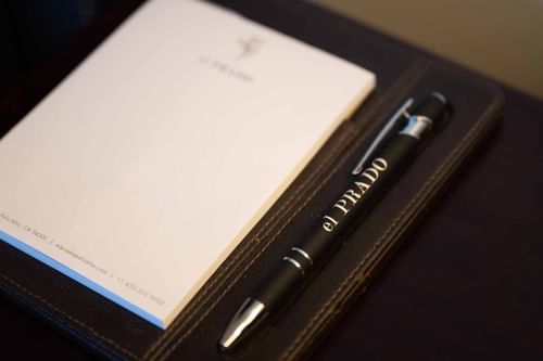 Close-up of the El Prado Hotel branded pen and notepad