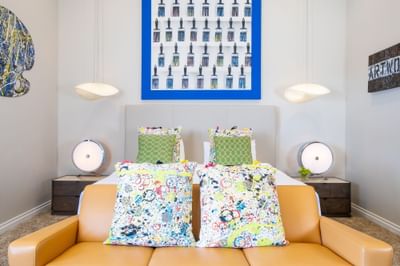 King bed, comfy sofa, bedside cupboards with lamps in King Premiere Studio at Retro Suites Hotel