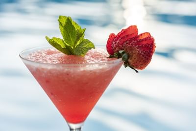 Close-up of a served cocktail glass by the pool at Hotel Isla Del Encanto
