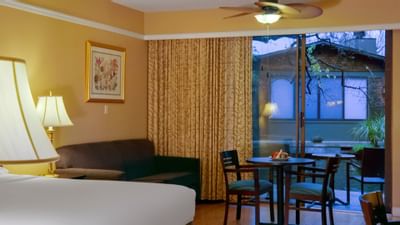 couch and tables next to sliding doors in yellow room