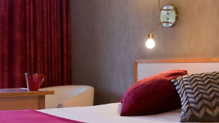 Closeup of Bedroom with pillows at Hotel L'Arc-En-Ciel