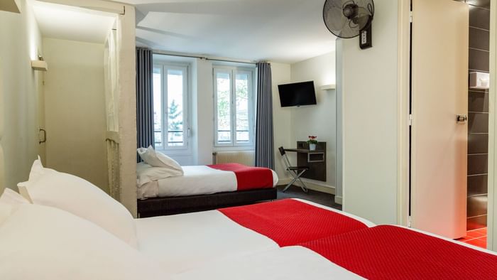 Interior of a bedroom with a comfy bed at Hotel Lecourbe