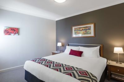 King bed in 2-Bedroom/1-Bathroom Apartments at Nesuto Hotels