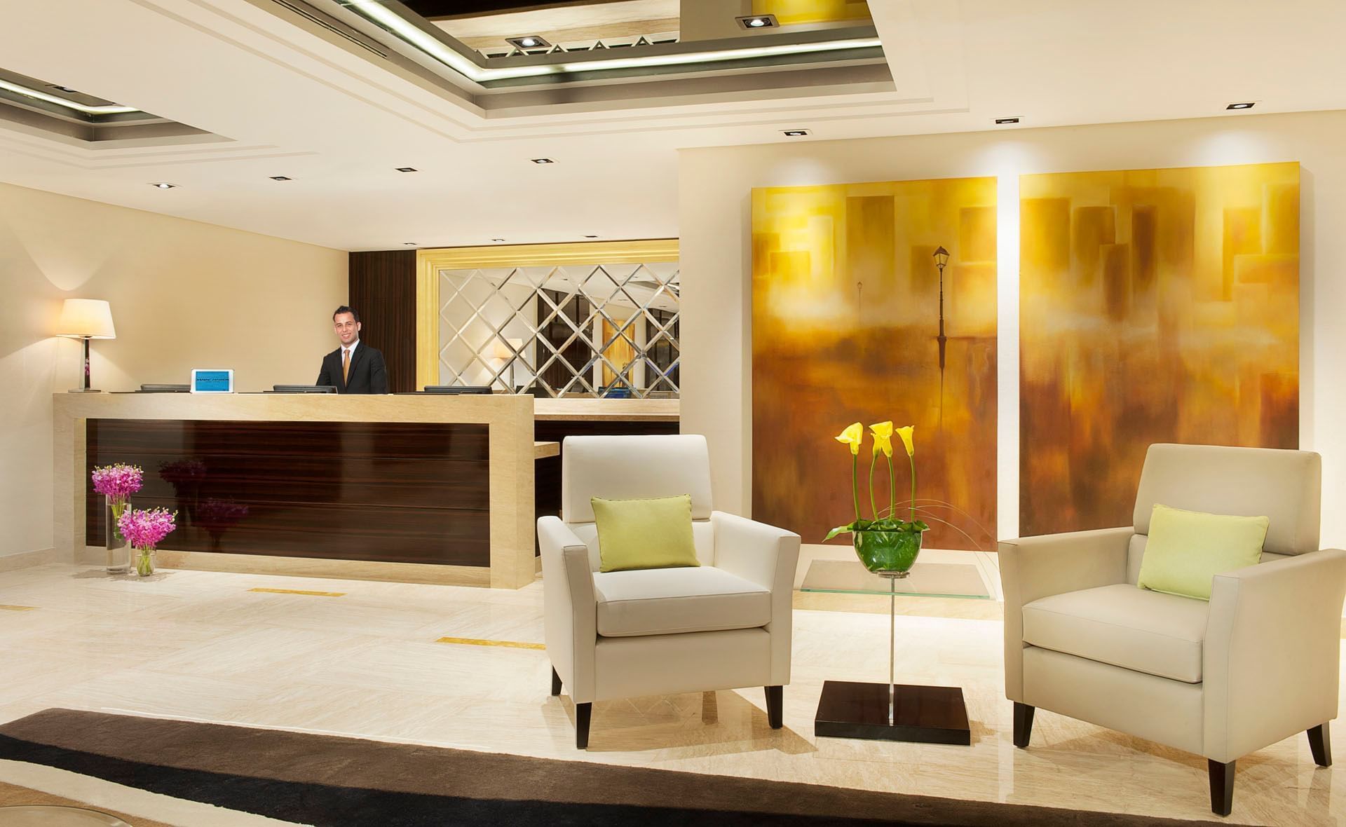 Receptionist in charming interior of reception area at DAMAC Maison Canal Views