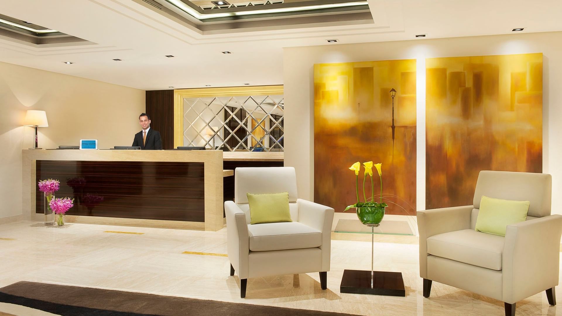Receptionist in charming interior of reception area at DAMAC Maison Canal Views