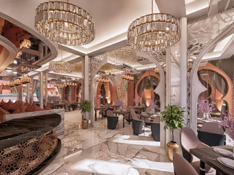 Italian Restaurant with elegant dining tables by ornate arched panels at Palmeraie Golf Palace by Pickalbatros