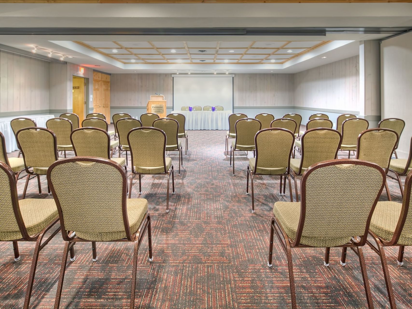 Pine Room with arranged chairs and a screen at Fairmont Hot Springs Resort