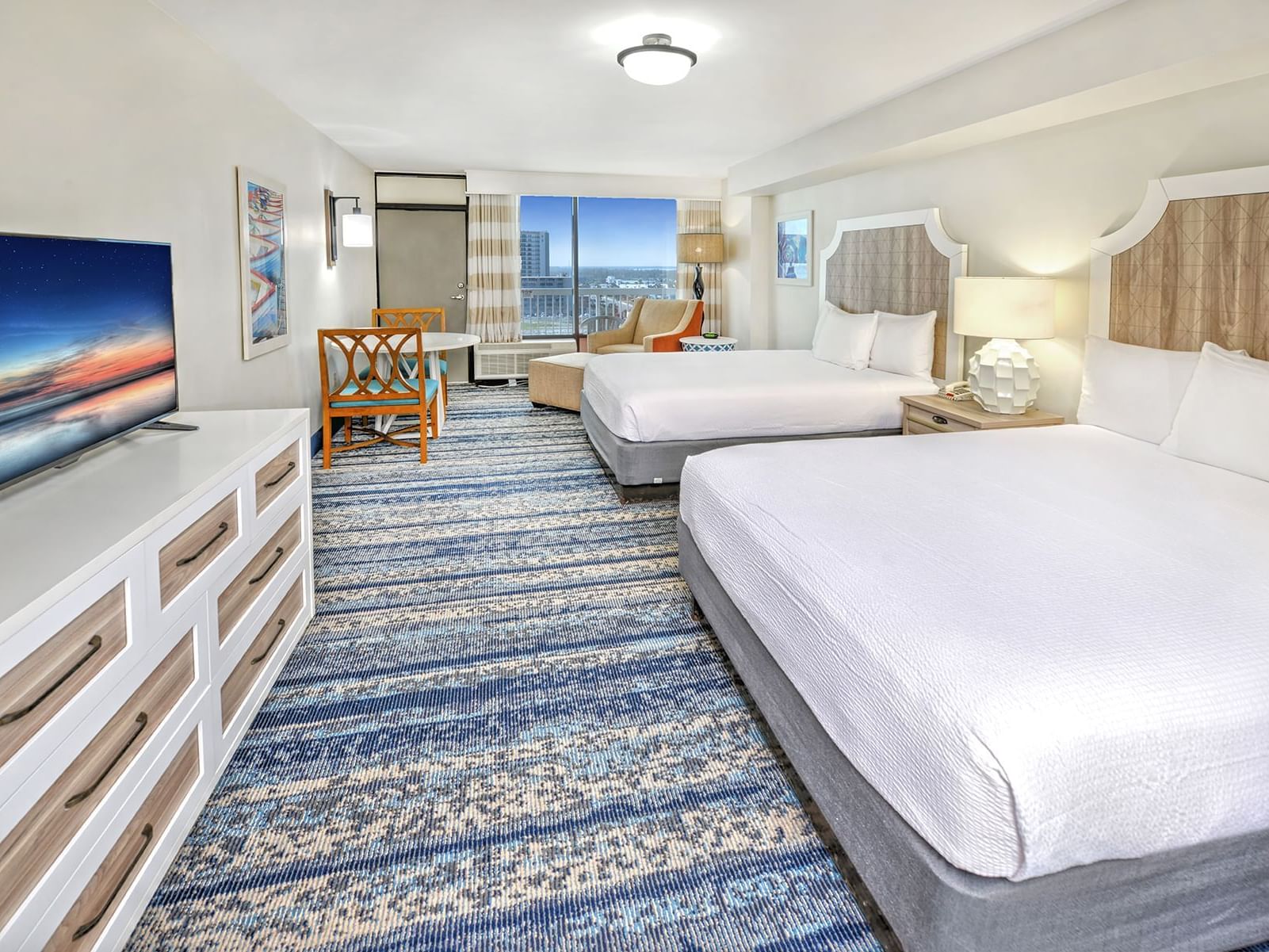 Two beds with ocean view in a room with kitchenette at Bahama House Daytona Beach.