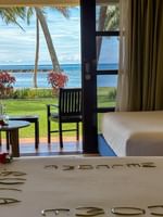 Ocean View Room at The Naviti Resort in Korolevu with beds, table, and ocean view.