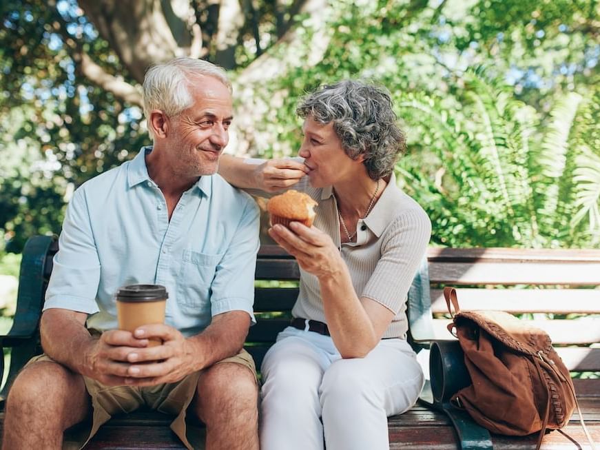 elderly couple sitting on a bench