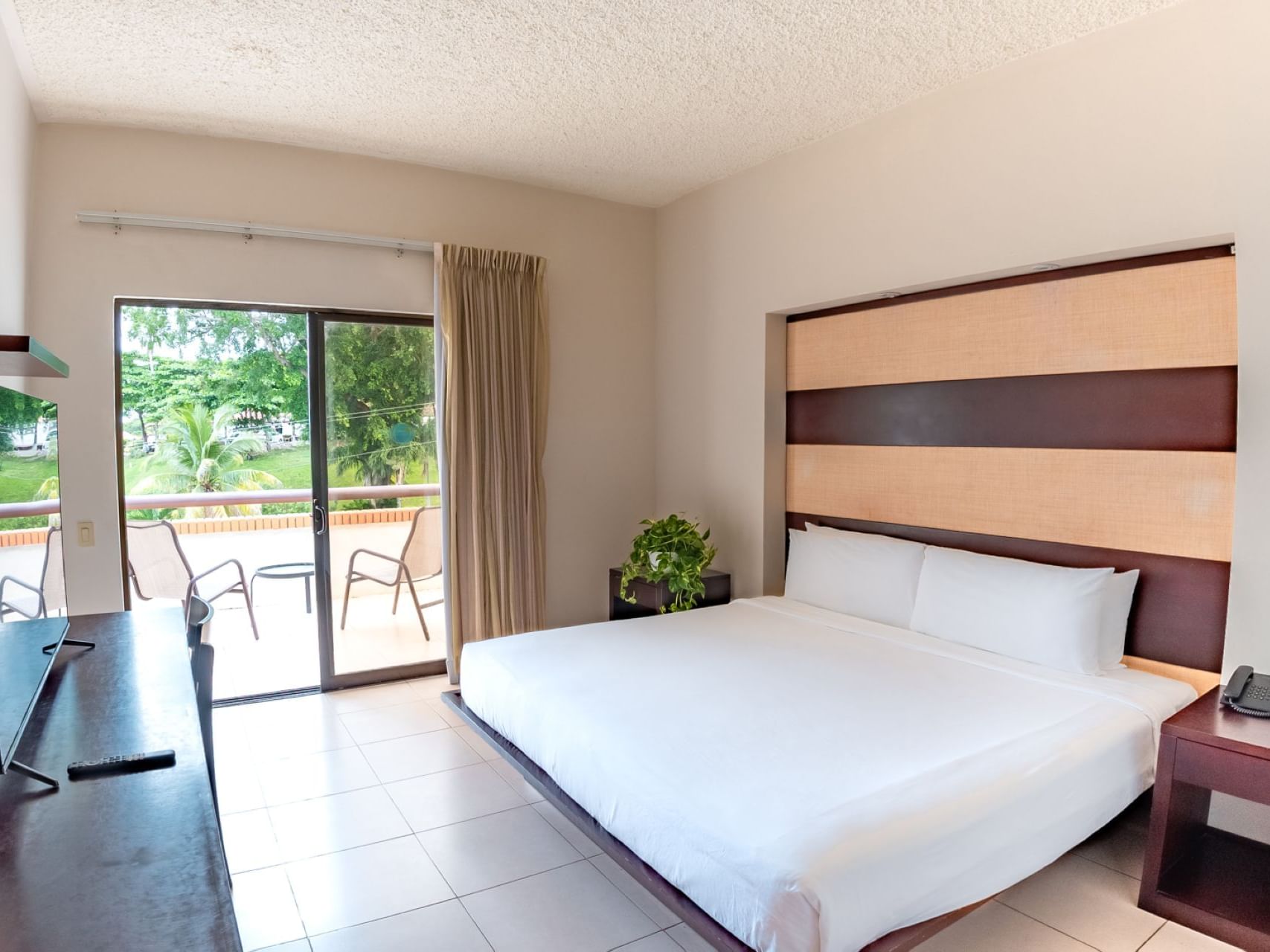 King bed in Deluxe Room at Villas Sol Beach Resort