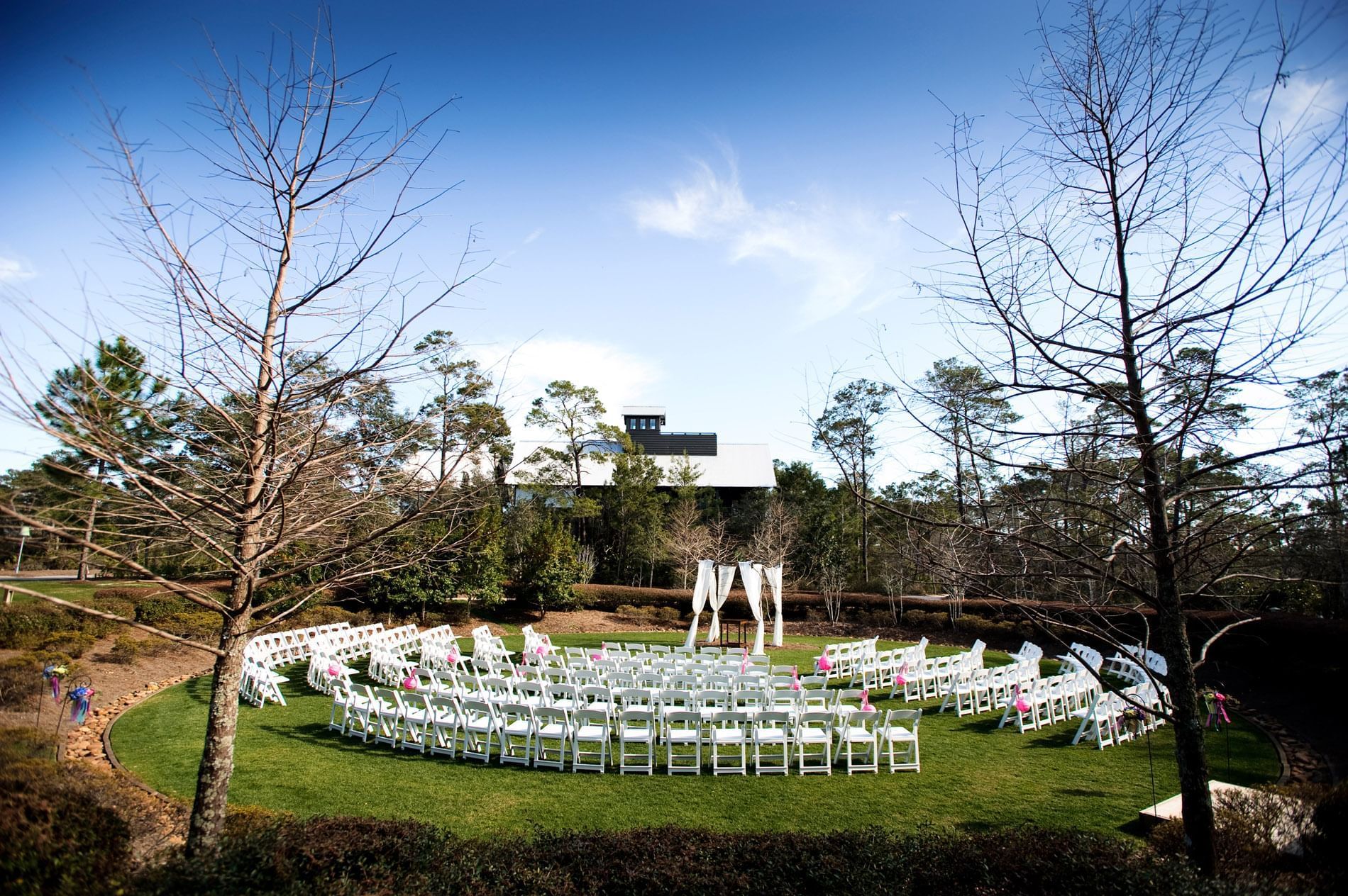 An outdoor wedding setup in Western Lake Park at WaterColor Inn