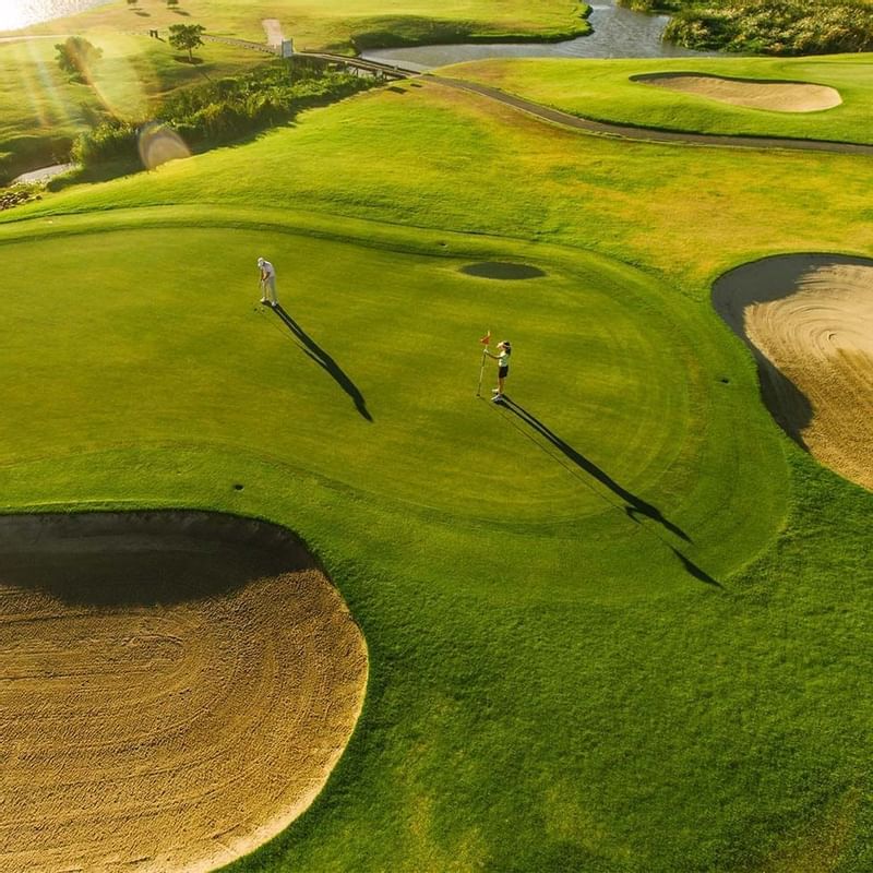 Aerial view of 2 golfers in a golf course, Falkensteiner Hotels