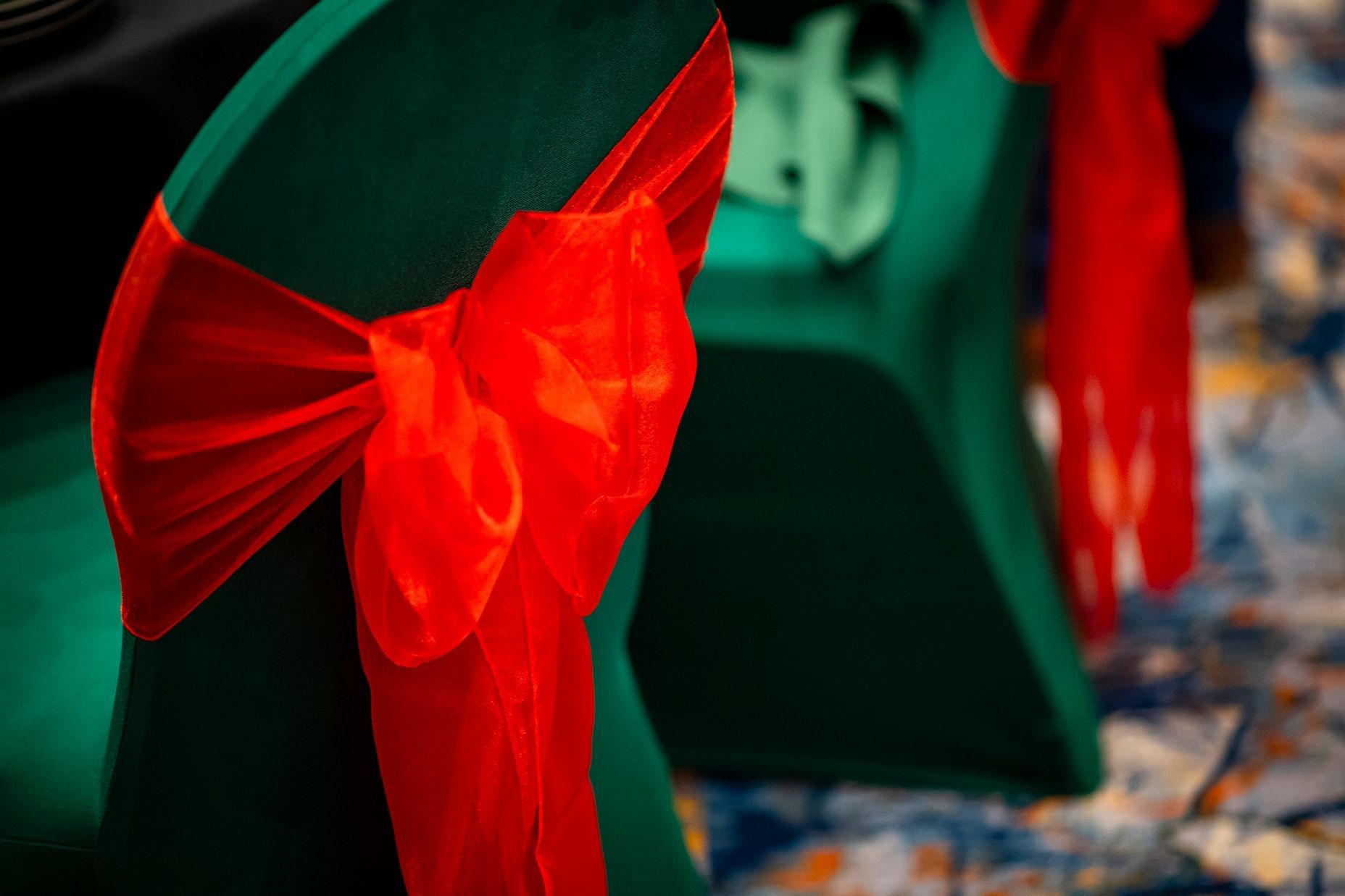 Close-up of red satin bow on green chair at Hotel Grand Chancellor Adelaide