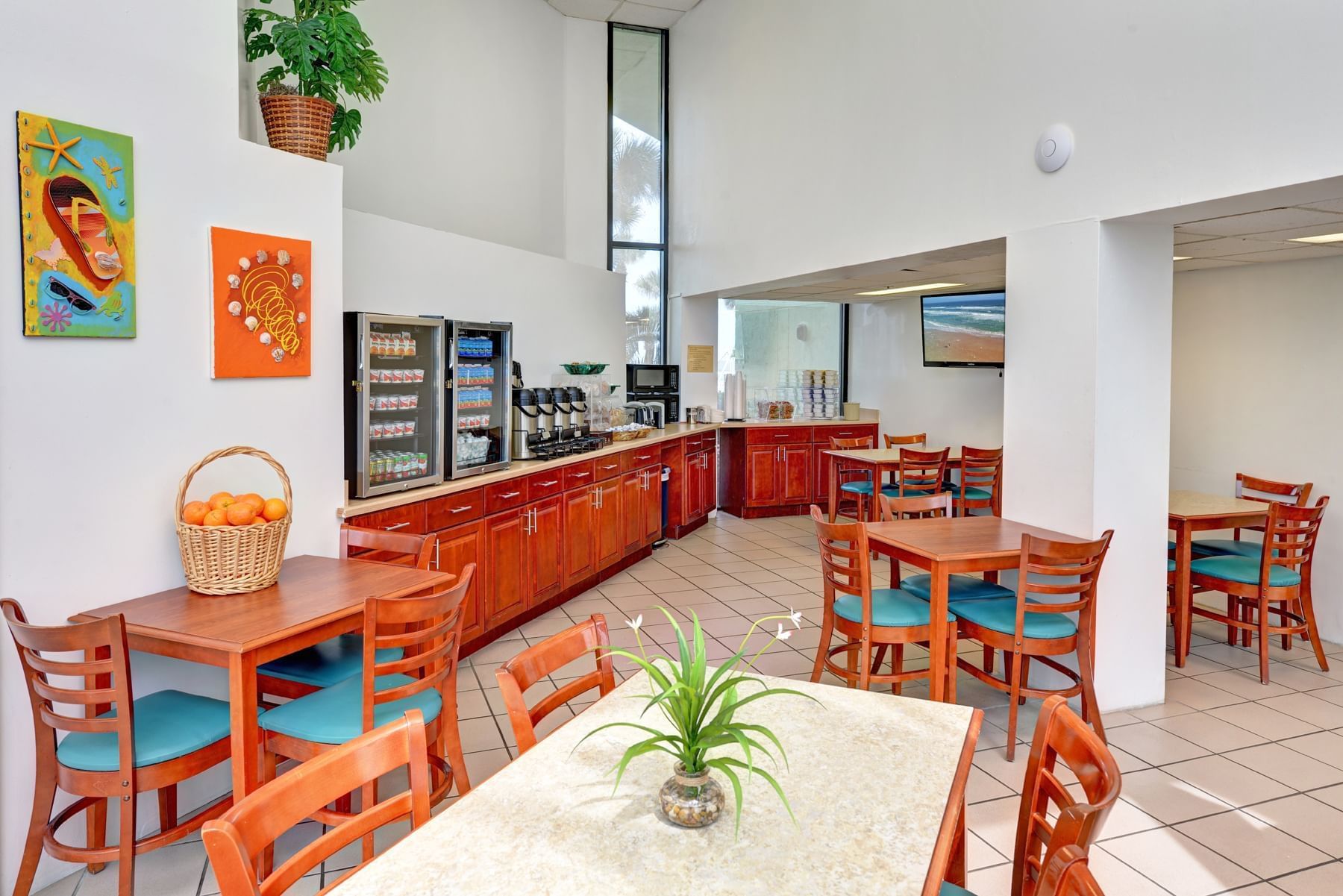 a hotel breakfast area with tables and chairs