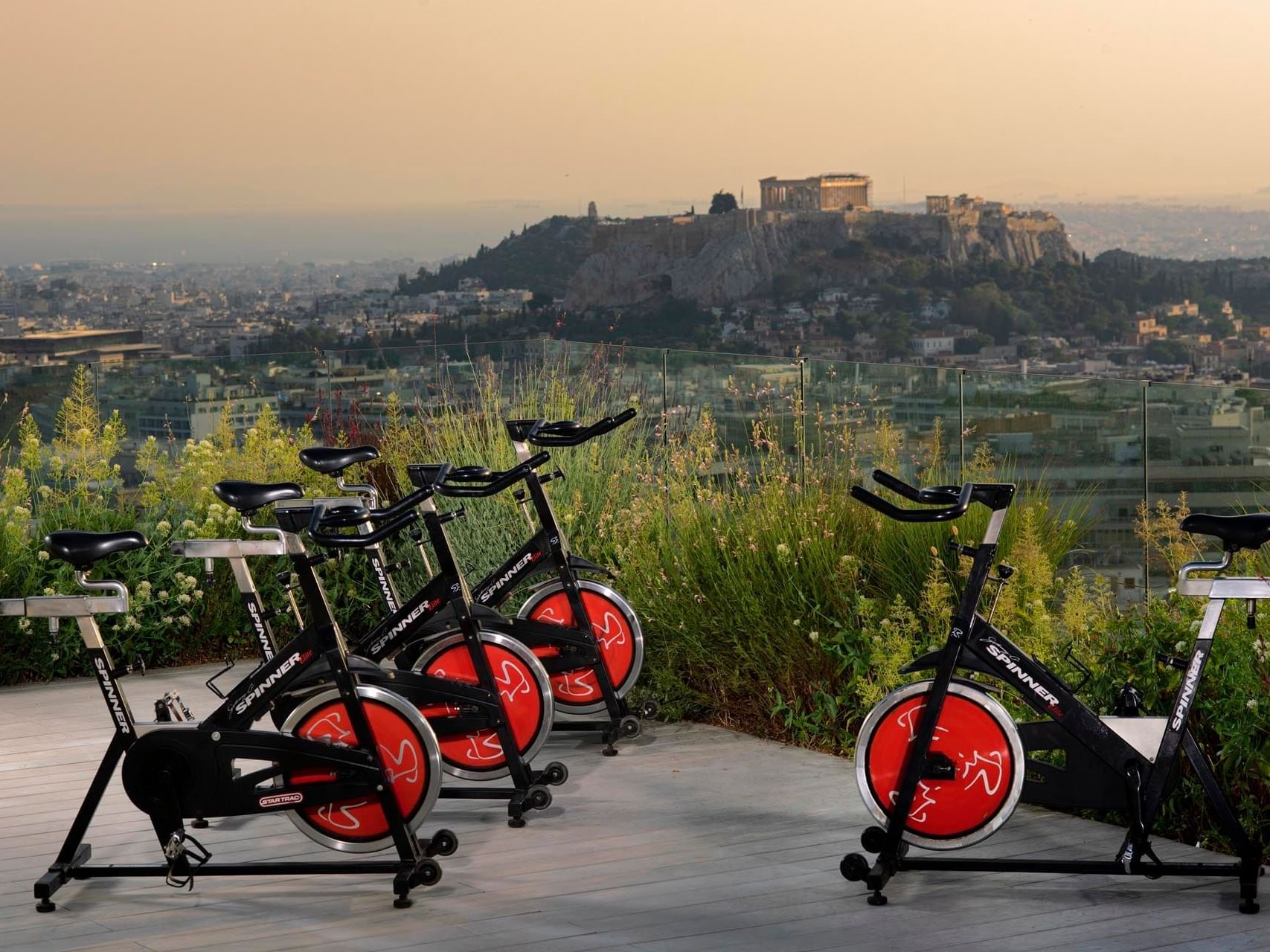 Exercise bikes by city view at St George Lycabettus