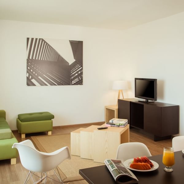 Living area with TV in Junior Suite King at Fiesta Inn