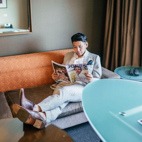 Businessman reading a magazine at Pullman Sydney Olympic Park