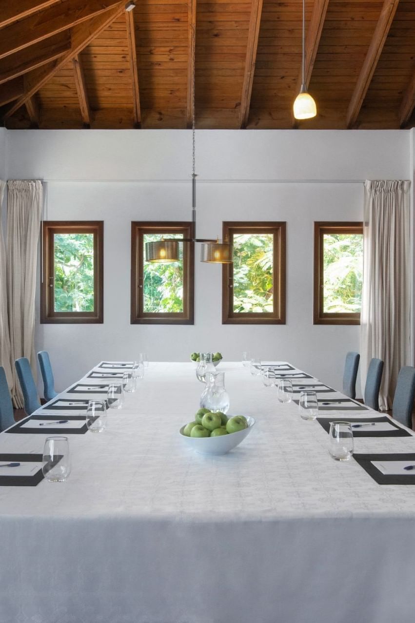 A meeting table with notepads & water glasses at Club Hemingway