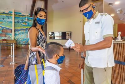Staff checking Covid -19 check on the boy at Fiesta Resort