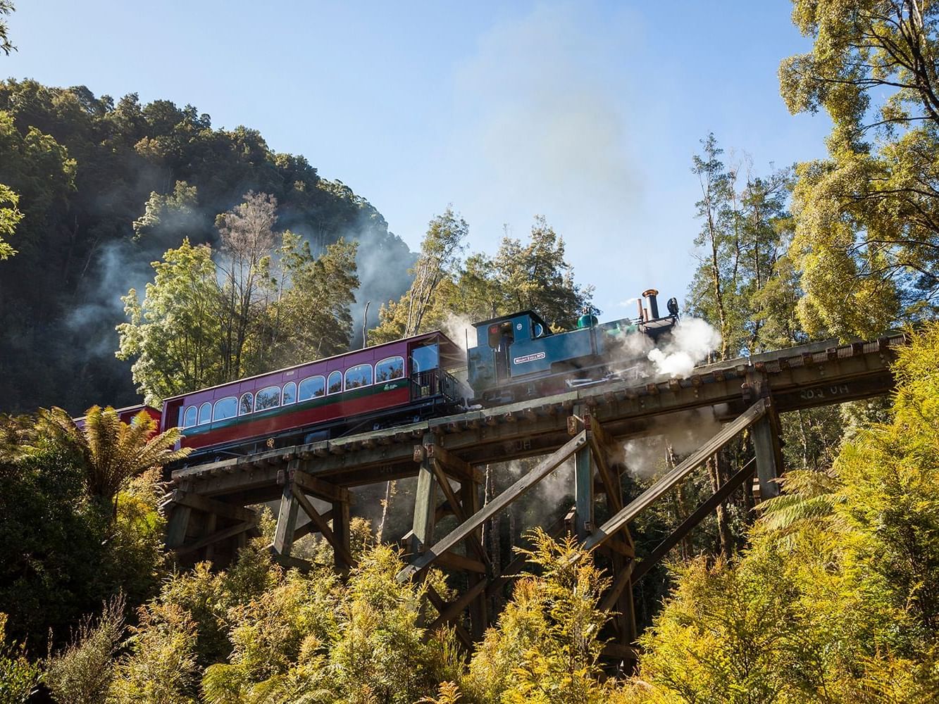 Low-angle view of a train running on a bridge near Strahan Village