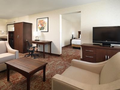 Living area with TV and vanity in King Executive Jetted Tub Suite at Crystal Inn Hotel & Suites