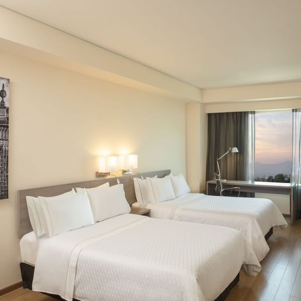 Double beds in Superior Room with working desk at Fiesta Inn