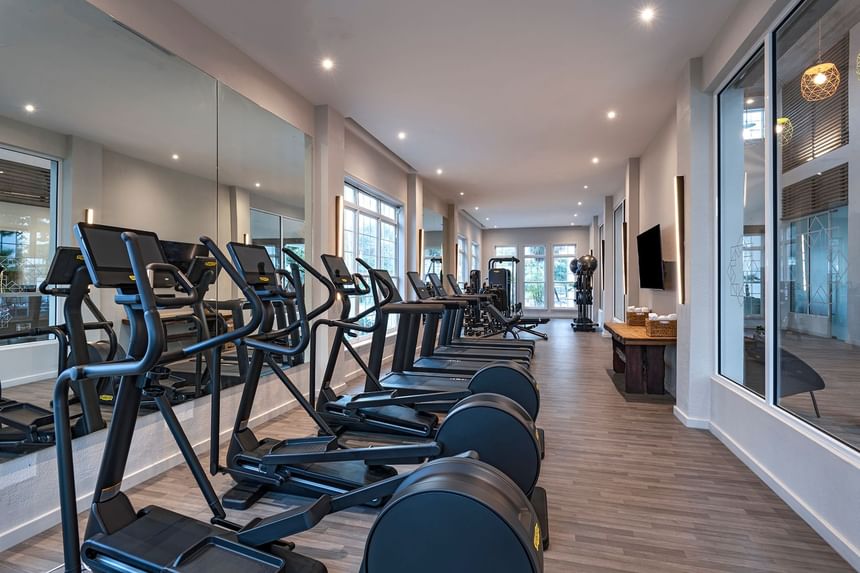 A well-equipped fitness center with wooden floors at Alaia Belize Autograph Collection
