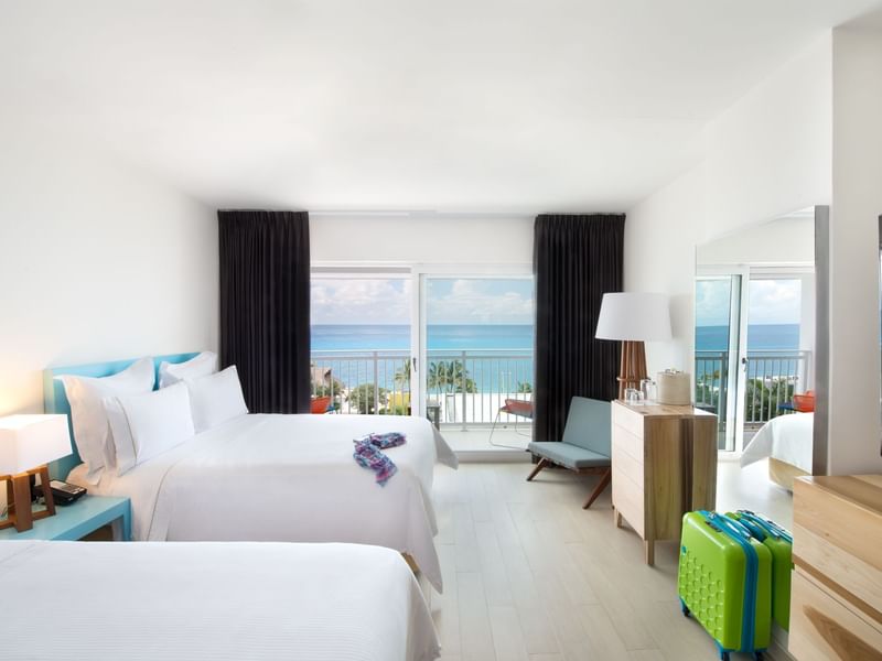 Deluxe Ocean View, 2 Double with two beds, couch and suit cases at Fiesta Americana Cozumel All Inclusive