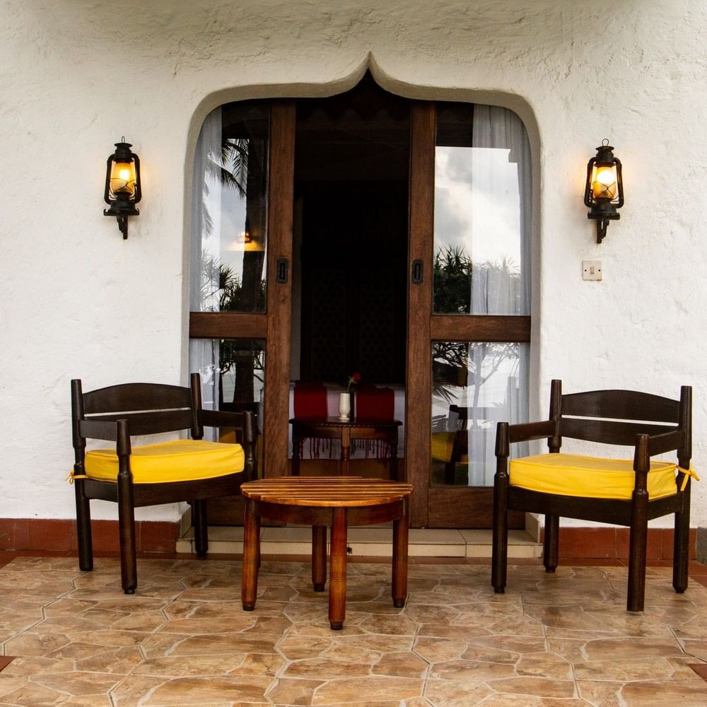 Chairs and table outside a Superior Sea View Room at Serena Beach Resort & Spa, Mombasa.