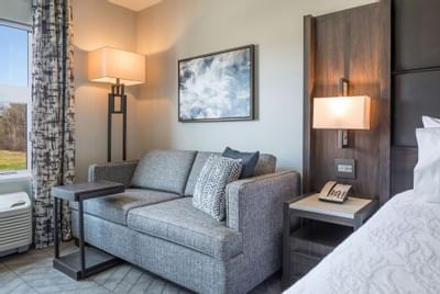 couch next to bed in hotel room