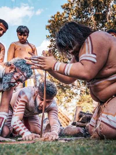 Group of First Nations men showing a traditional fire-lighting near Sofitel Brisbane Central