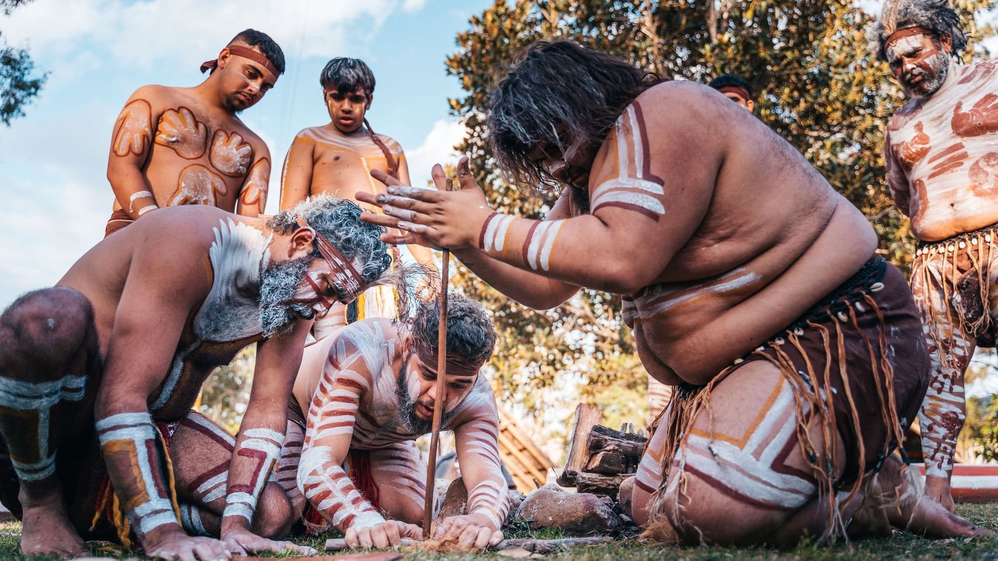 Group of First Nations men showing a traditional fire-lighting near Sofitel Brisbane Central